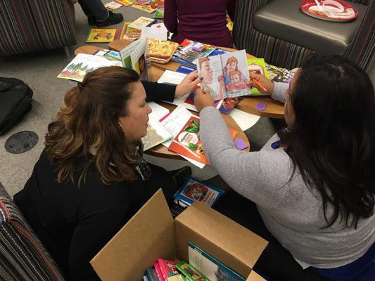 Two teachers looking over some books